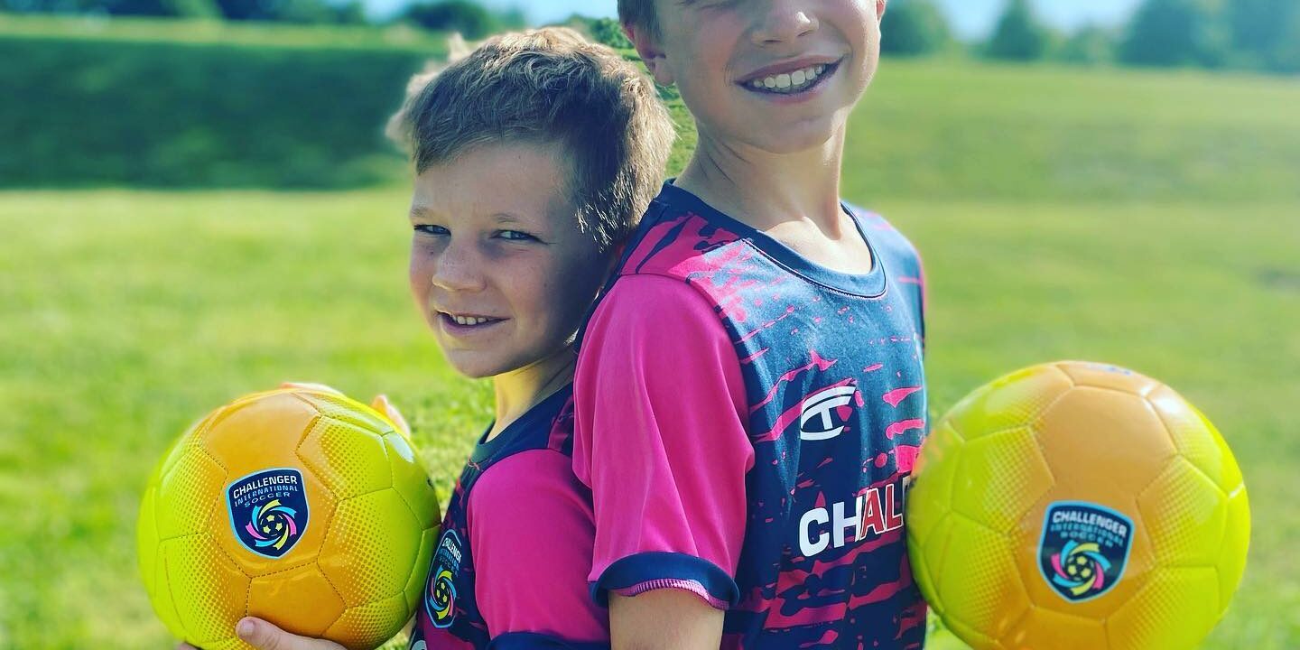Young players posing with their soccer balls Young players posing with their soccer balls