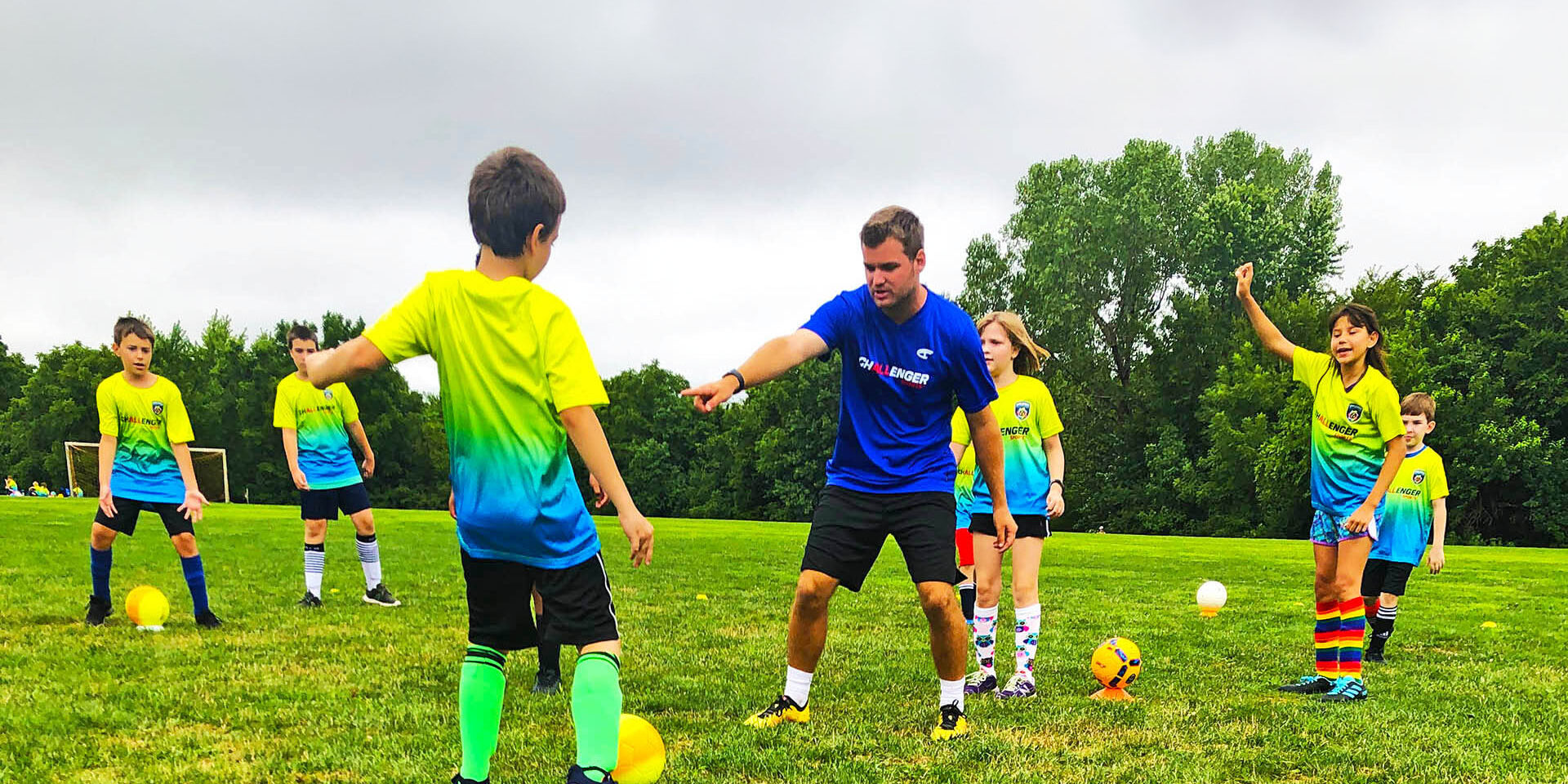 Challenger Sports Coach Instructing Young Soccer Campers Challenger Sports Coach Instructing Young Soccer Campers