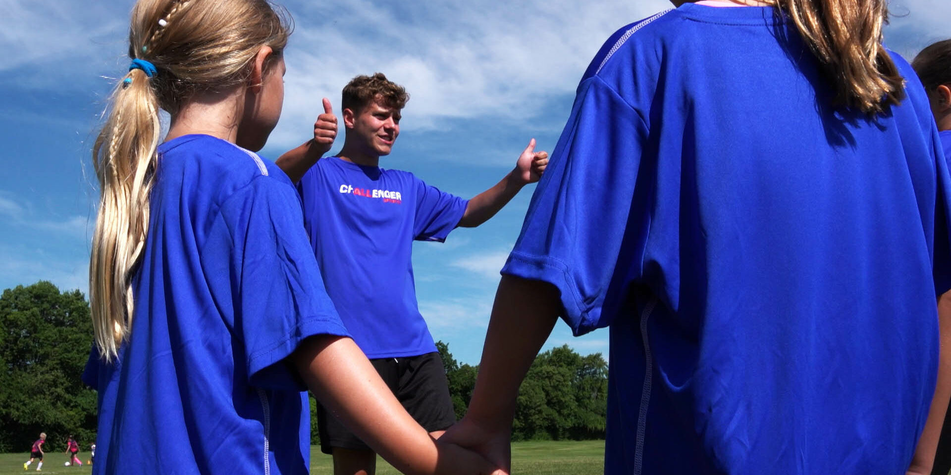 Coach giving campers a thumbs up on camp Coach giving campers a thumbs up on camp