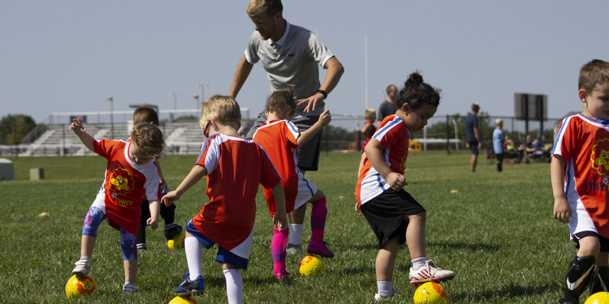 TinyTykes young players learning fundamental skills with coaches on camp TinyTykes young players learning fundamental skills with coaches on camp
