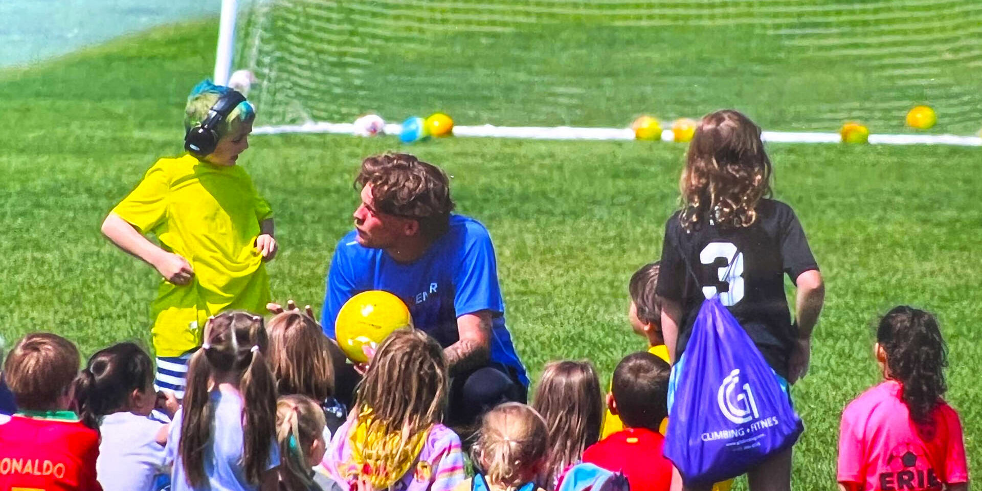 Coach talking with kids at the start of camp Coach talking with kids at the start of camp
