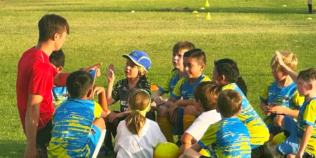 Kids talking with coaches on camp asking questions Kids talking with coaches on camp asking questions